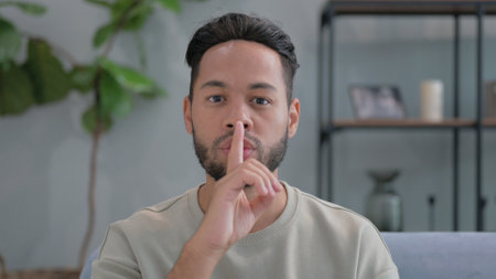 Silence Please Gesture by Man at Homeの写真素材