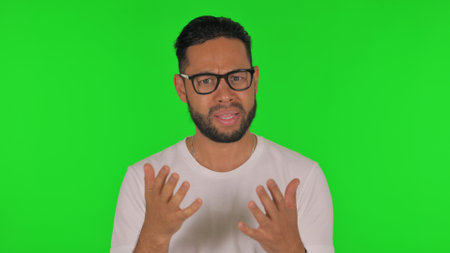 Angry Man Talking in Anger on Green Backgroundの写真素材