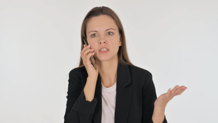 Portrait of Angry Businesswoman Talking on Phone on White Backgroundの写真素材
