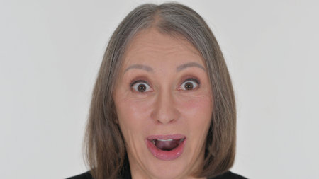 Close up of Senior Woman Wondering in Shock on White Backgroundの写真素材