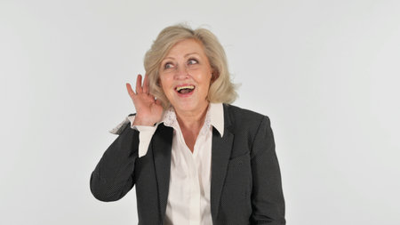 Senior Business Woman Trying to Listen on white Backgroundの写真素材