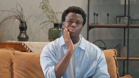 Portrait of African Man with Toothache at Homeの写真素材