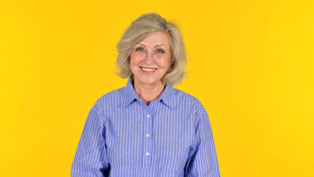 Smiling Old Woman on Yellow Background, Portrait