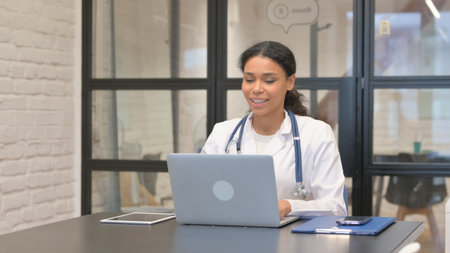 African Female Doctor Talking with Patient Onlineの写真素材