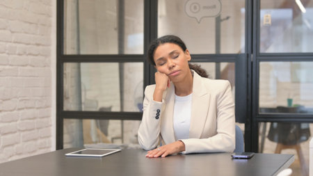 Tired African Business Woman Sleeping in Officeの写真素材