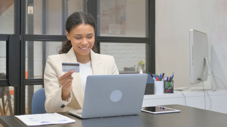 African Business Woman Enjoying Online Banking at Workの写真素材