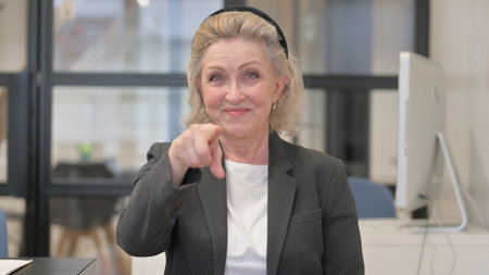 Portrait of Senior Old Business Woman Pointing at Camera