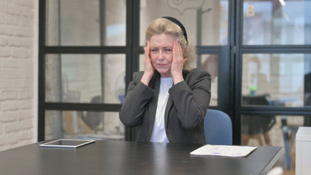 Senior Old Business Woman with Headache in Office