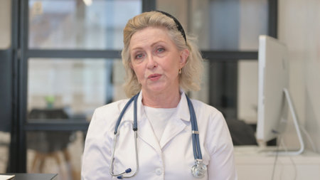 Senior Female Doctor Doing Video Chat, Webcam Viewの写真素材