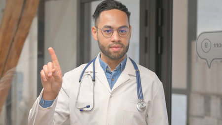 Portrait of Restricting African Male Doctor in Denial