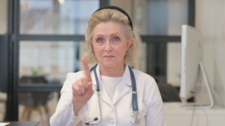 Portrait of Restricting Senior Female Doctor in Denialの写真素材