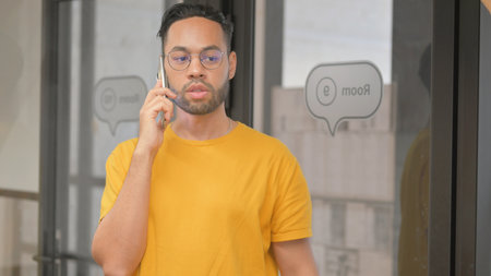 Portrait of Casual Young African Man Talking on phoneの写真素材