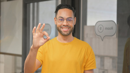 Portrait of Casual Young African Man with Okay Signの写真素材