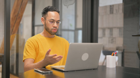 Creative Mixed Race Man Doing Video Chat via Laptop