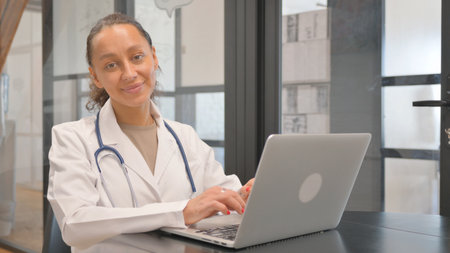 Multiracial Female Doctor Working on Laptopの写真素材