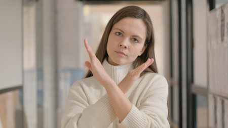 Portrait of Displeased Young Woman with Rejecting Gestureの写真素材
