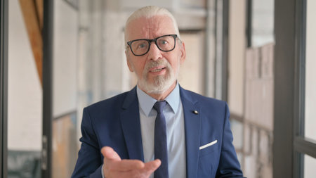 Webcam View of Old Businessman Doing Video Chatの写真素材