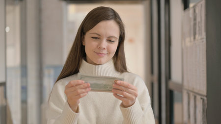 Portrait of Happy Young Woman Counting Moneyの写真素材