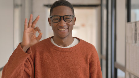Portrait of African Man with Okay Gesture Looking at Camera
