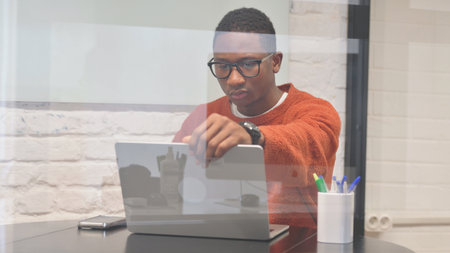 African Man Coming to Workspace after Opening Laptop