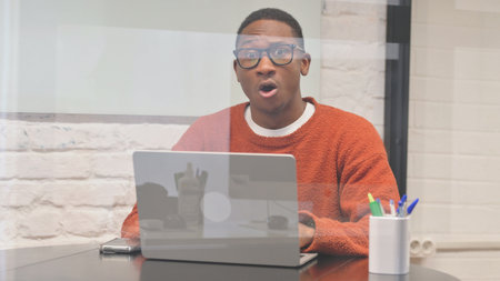 Working African Man Shocked while Looking at Camera