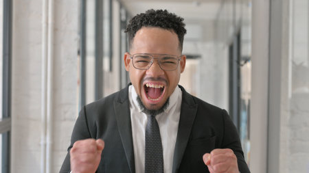 Portrait of Hispanic Businessman Celebrating Successの写真素材