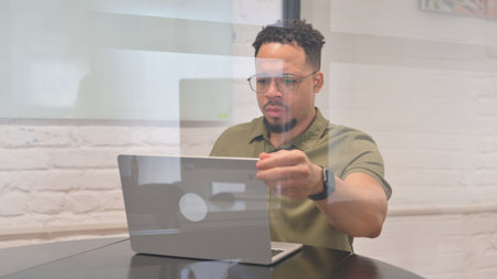 Multiracial Man Leaving Workspace, Getting Late for Meetingの写真素材