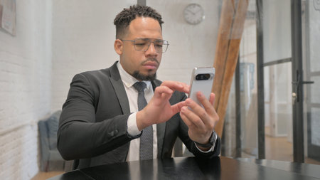 Multiracial Businessman Typing Message on Phone