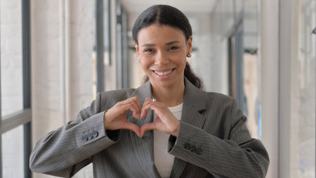 Handmade Heart Gesture by Happy African Businesswoman