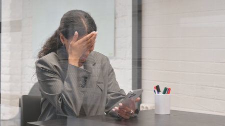 African Businesswoman with Trading Loss on Phone