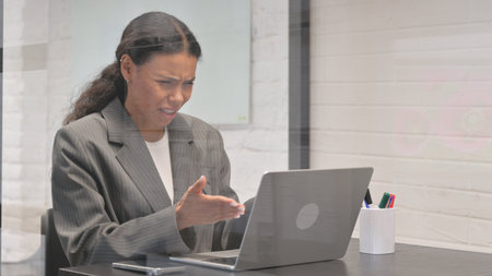 African Businesswoman Shocked by Loss on Laptopの写真素材