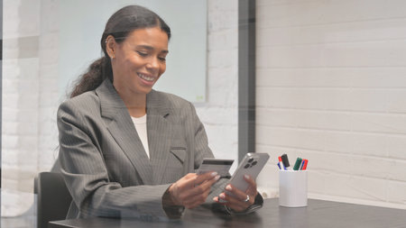 Online Banking with Smartphone by African Businesswoman