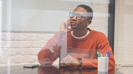 Pensive African Man Brainstorming New Idea at Workの写真素材
