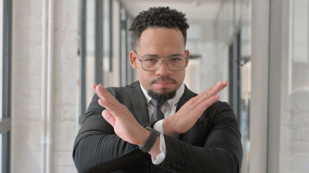 Portrait of Displeased Hispanic Businessman with Rejecting Gestureの写真素材