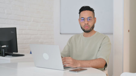 Hispanic Man Looking at Camera in Officeの写真素材