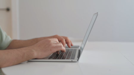 Side View of Man Typing on Laptop