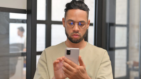Portrait of Hispanic Businessman Using Phone