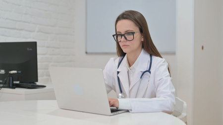 Young Doctor with Thumbs up Looking at Camera