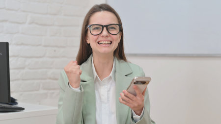 Portrait of Business Woman Excited for Online Success on Phone