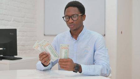 Young African Businessman Counting Money at work