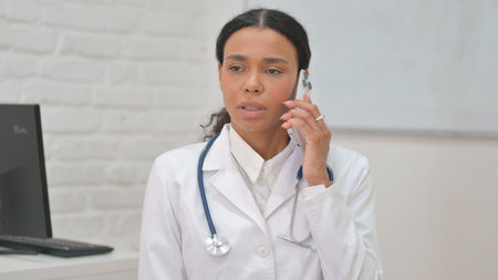 Portrait of African Female Doctor Talking on Phoneの写真素材