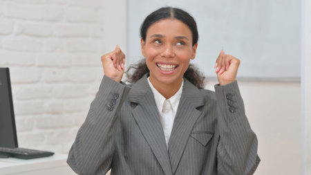 Portrait of an African Business Woman Celebrating Successの写真素材