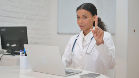 Displeased African Female Doctor Denying Patientの写真素材