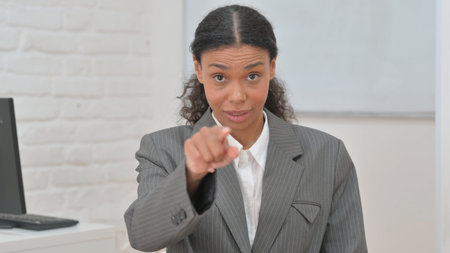 Portrait of African Business Woman with Pointing Gestureの写真素材