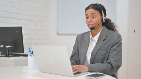 Woman with Headset in Call Center Doing Video Chat at Work