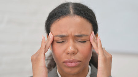Close up of African Business Woman with Headache
