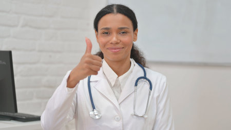 Portrait of African Female Doctor with Thumbs upの写真素材