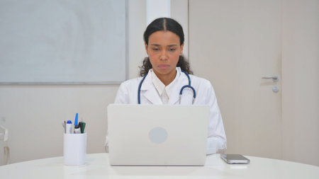 Young African Doctor Working on Laptopの写真素材