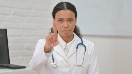 Portrait of Stopping African Female Doctor in Denialの写真素材