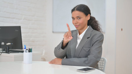 African Business Woman in Denial Looking at Camera while Sitting in Officeの写真素材